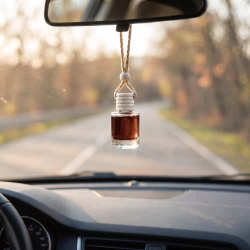 Chocolate Cake car air freshener hanging from a rearview mirror