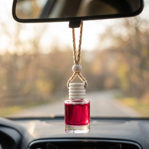 Dragons Blood car air freshener hanging from a rearview mirror