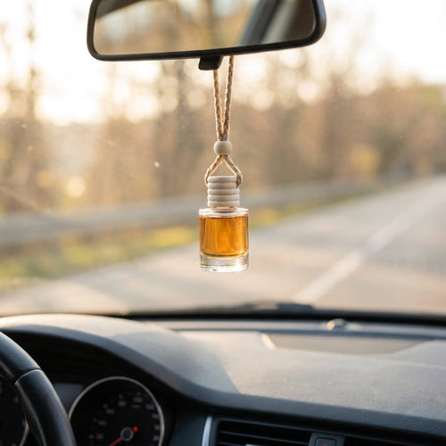 Eat Me Raw car air freshener hanging from a rearview mirror